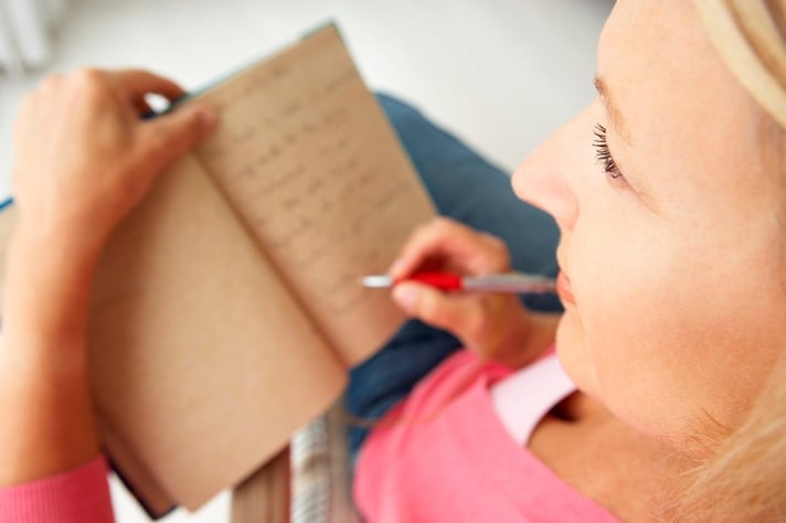 woman writing in journal 