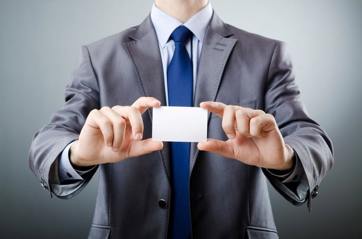 Businessman_holding_blank_business_card.jpg